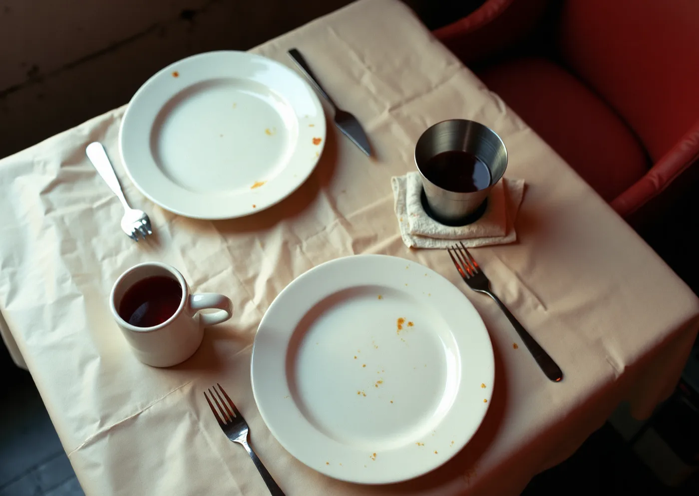 Paper laid over a tasca table, halfway through lunch, creased from the roll and marked by the meal.